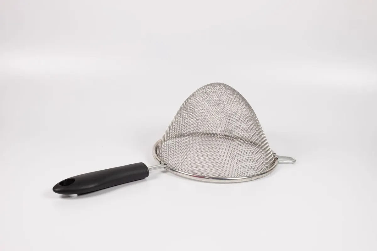 thrifted metal kitchen colander hand holding