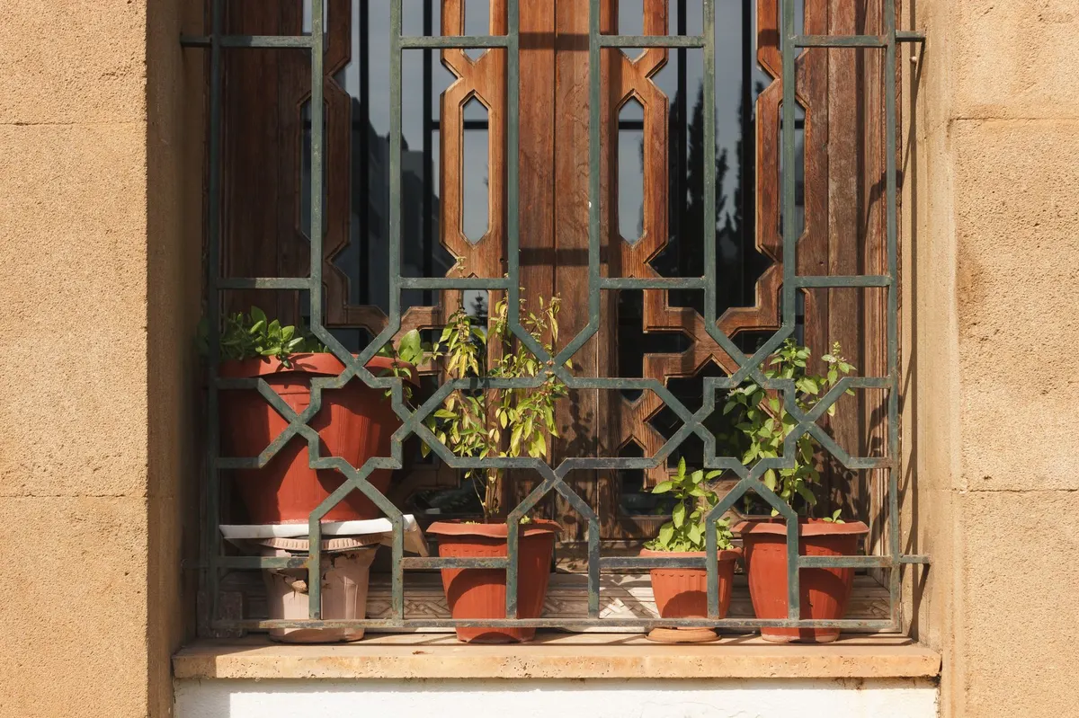 vintage metal plant stand styled with terracotta pots