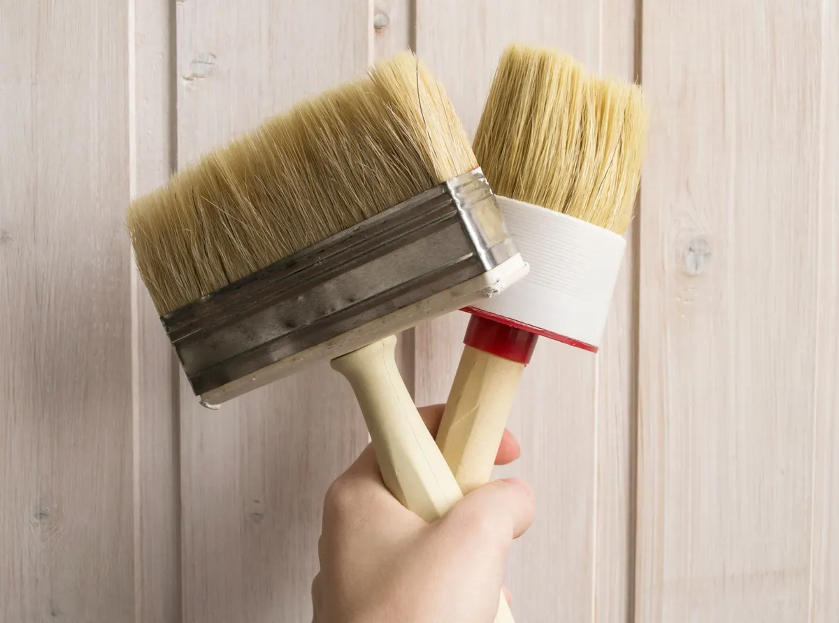 painting wooden home decor with chalk paint and brush