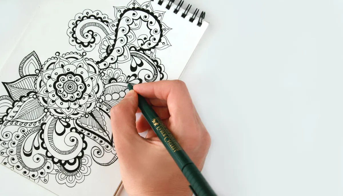 drawing bone inlay pattern white paint pen charcoal wood close up