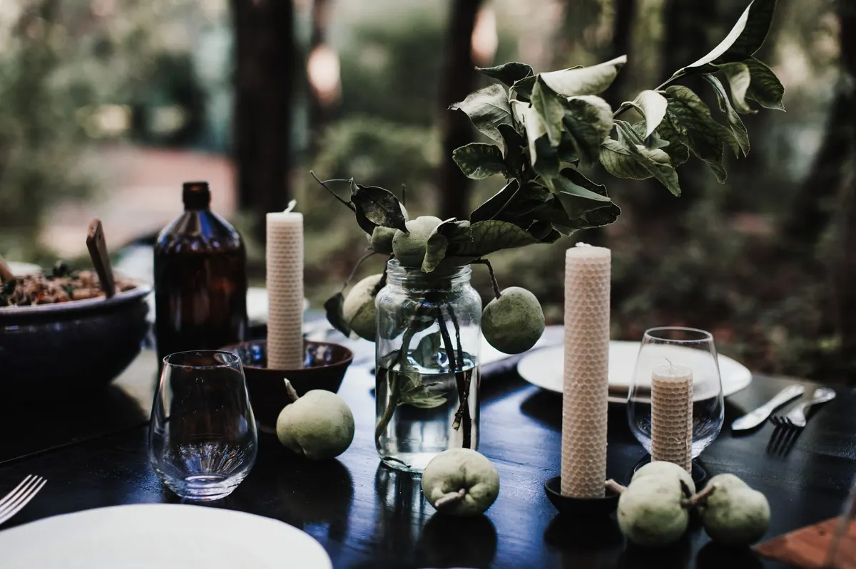 table centerpiece styling fresh pears eucalyptus branches candlelight